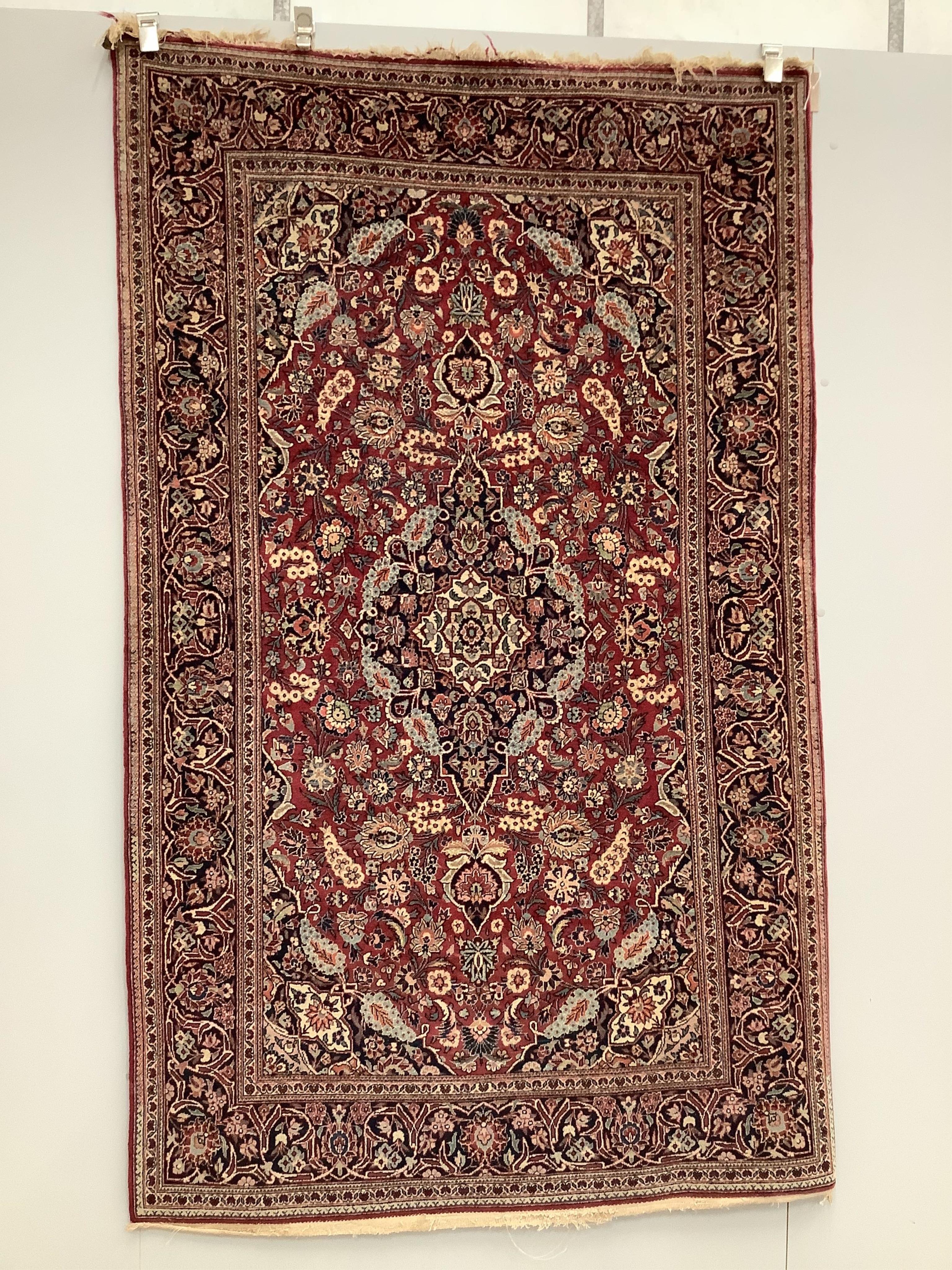 An Isphahan blue medallion rug, with a pink field, 210 x 128cm. Condition - fair